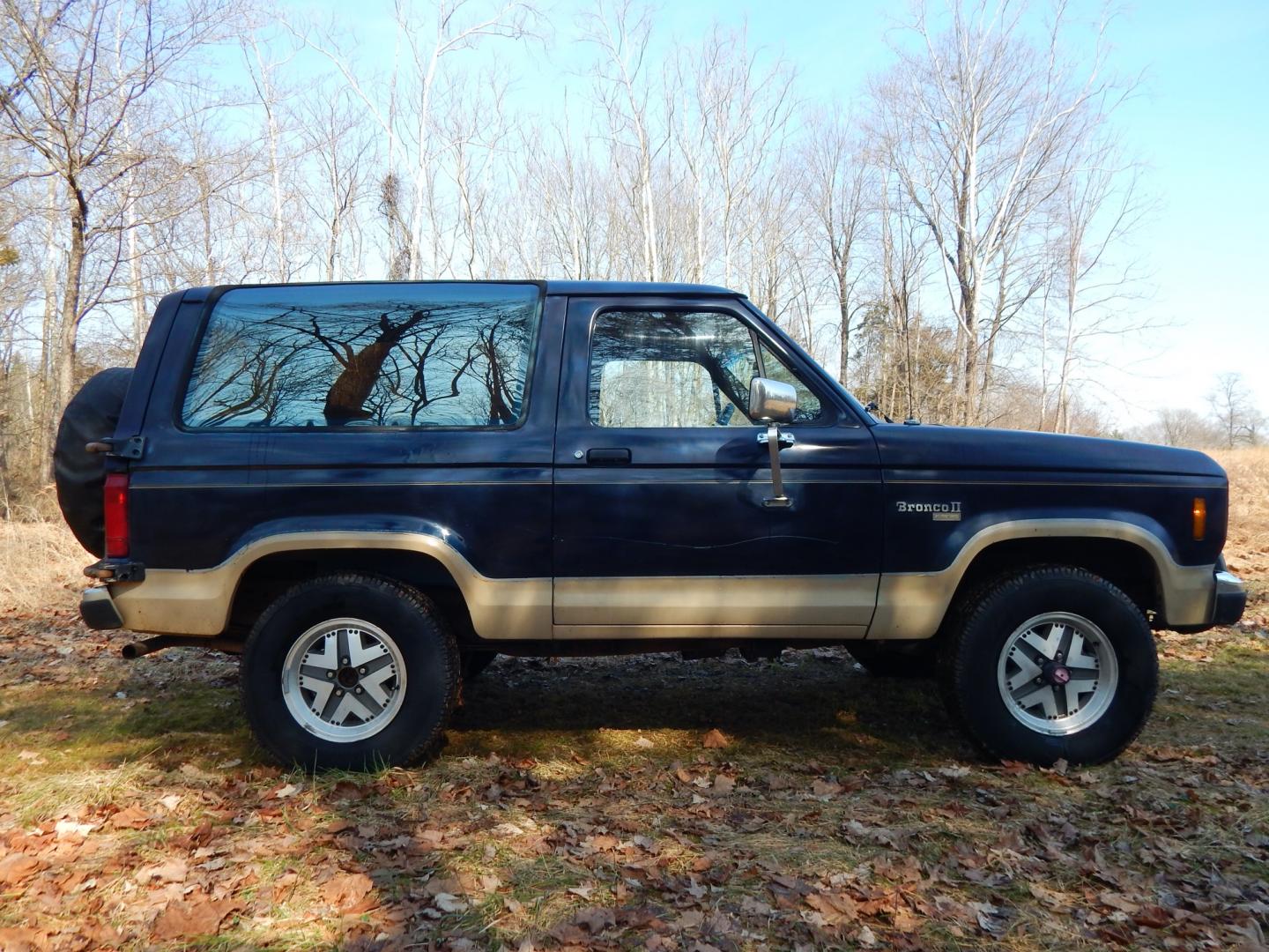 1988 Blue /Tan Ford Bronco II 4WD (1FMCU14T6JU) with an 2.9L V6 OHV 12V engine, 4-Speed Automatic Overdrive transmission, located at 6528 Lower York Road, New Hope, PA, 18938, (215) 862-9555, 40.358707, -74.977882 - Here we have a 1988 Ford Bronco 2 with a 2.9L V6 putting power to a 4x4 automatic transmission. Options include: tan cloth interior, heat/AC, XD Vision radio, power windows, cruise control, tilt steering wheel, front/rear defrost windows, spare tire cover, 15 inch alloy wheels with 4 Solarus AP tire - Photo#5